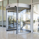 revolving door / rotating / aluminium / glass