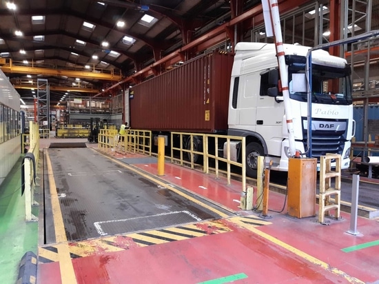 General view of warehouse with various truck lift tables