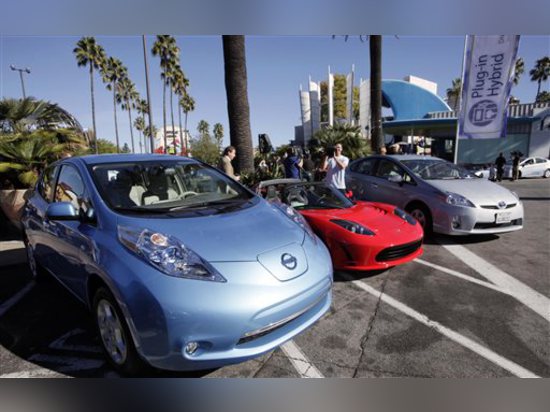 This Dec. 13, 2013 file photo shows from left, electric cars from Nissan,Tesla, and Toyota presented at a news conference in Los Angeles. (AP Photo/Nick Ut,File)