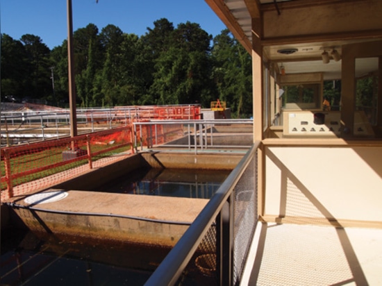 Existing filters (foreground) and associated control room with clarifying tanks (left) and partially completed expansion tanks in the background. Ultimate capacity will be 8 MGD.